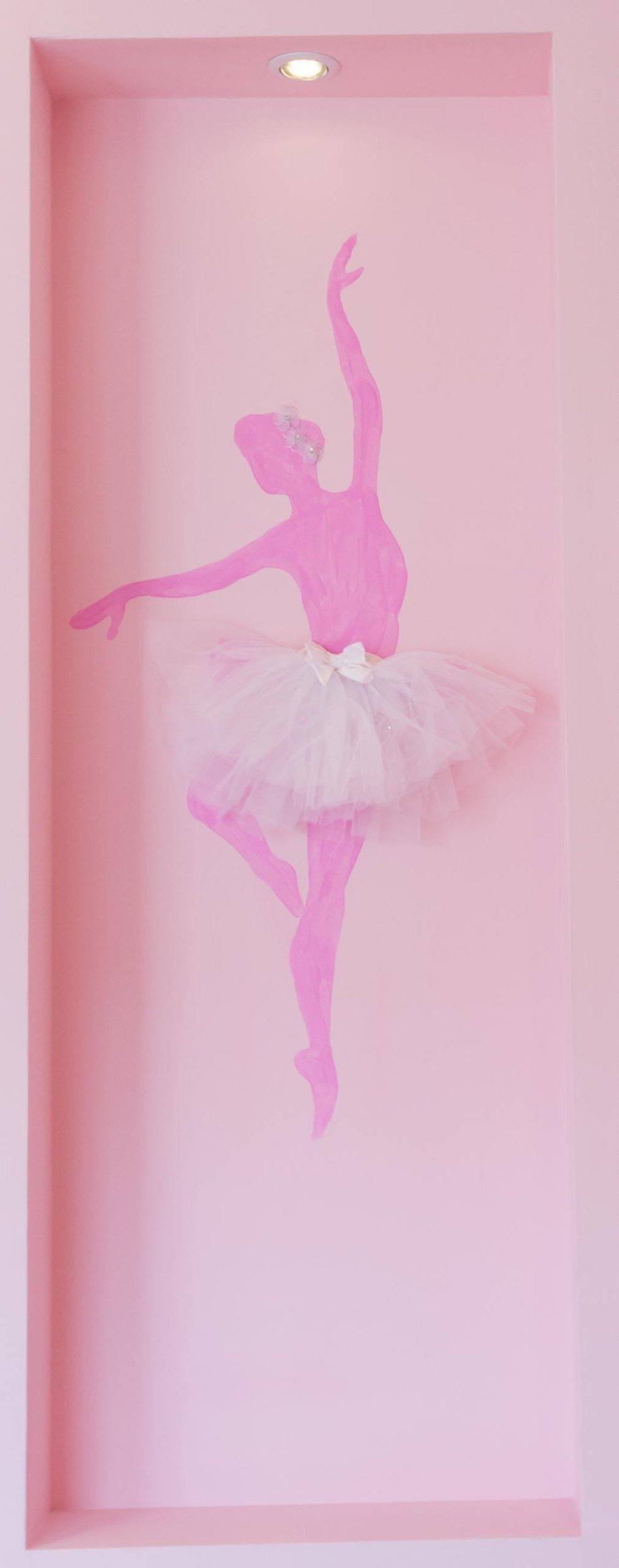 A pink ballerina painted in a wall niche